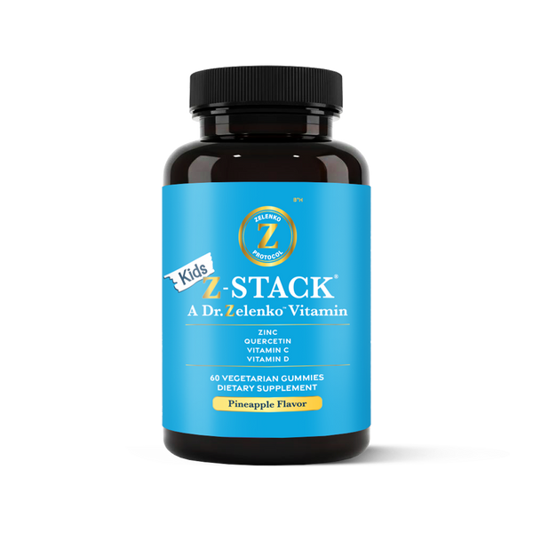 Bottle of Kids Z-Stack vitamins with blue label and black cap on white background