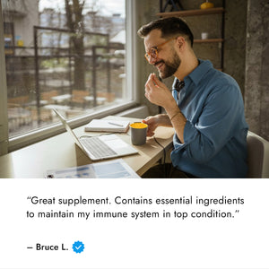 Z-DTox review with image of a man on couch taking a supplement in front of a laptop computer